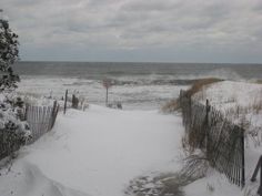 the path to the beach is covered in snow