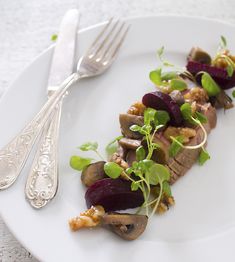 a white plate topped with meat and veggies