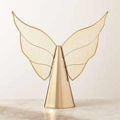 a golden angel sculpture on a marble surface