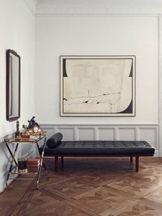 a living room with a couch, coffee table and art on the wall above it