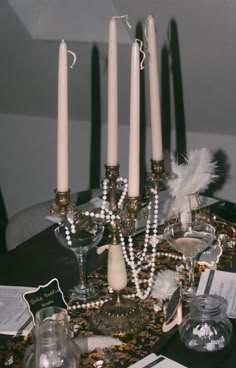 a table topped with candles and wine glasses