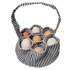 six eggs in a black and white striped fabric bag on a white background with stripes