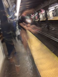 blurry photograph of people waiting on the subway platform