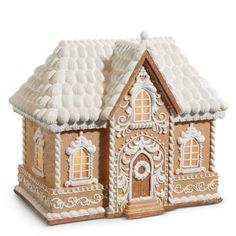 a gingerbread house with icing on it's roof is shown in front of a white background