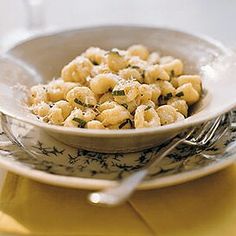 a bowl filled with macaroni and cheese on top of a yellow place mat