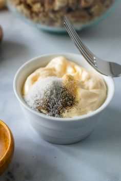 a bowl filled with food next to a spoon