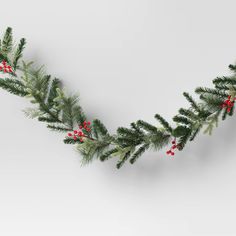 a christmas garland with red berries and pine needles