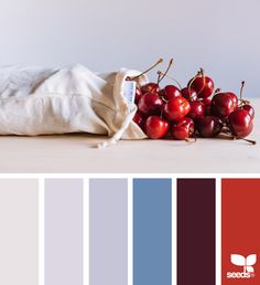 some cherries are sitting on top of a white bag and the color is blue