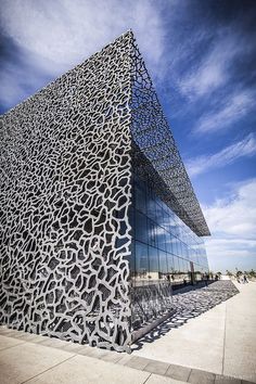 a building that has been designed to look like an animal skin pattern on the side