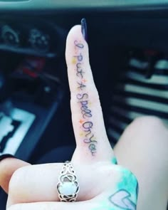 a person is holding up their finger with the word love written on it