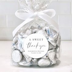 a bag filled with hershey kisses and a white bow on the top that says, a sweet thank you