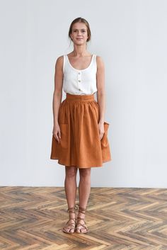 "Wrap Skirt Linen Tie Skirt, Prairie Skirt, Cottagecore Skirt with Pockets, Wrap Around Skirt, High Waist Swing Skirt Gathered Skirt, Grethel Grethel wrap midi linen skirt is for every dreamer who rejoices in the feeling of freedom, carelessness and pure joy. Designed as a midi high-waisted skirt that will make you swirl in delight. Inspired by 1950's when fashion embraced decorative femininity, our Grethel swing-style skirt is the true wardrobe hero, perfect for smart, casual, leisure, or simply pleasure. Frontal pockets add a lovely cottage core feel to it hence making it practical for small thingies to be tucked away and have them handy once needed. Cut from lightweight linen, this skirt is easily adjustable around the waist due to its partly-wraparound design. Complete the look with ou Gathered Wrap Skirt, Brown Pleated Tiered Skirt, Orange Relaxed Flared Skirt, Flowy Full Skirt Skort With Gathered Details, Orange Relaxed Mini Skirt, Casual Orange Pleated Skirt, Relaxed Fit Lined Mini Wrap Skirt, Flowy Full Skort With Gathered Details, Orange Relaxed Fit Mini Skirt