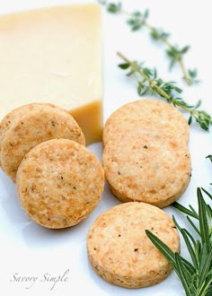 three crackers sitting next to a block of cheese