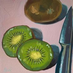 two kiwis cut in half next to a knife