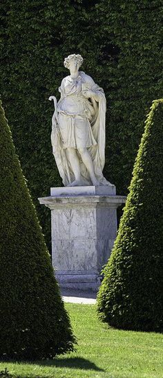 a statue in the middle of some bushes