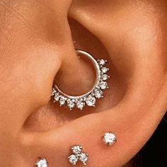 a woman with three piercings on her ear