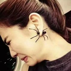 a woman with a spider tattoo on her head