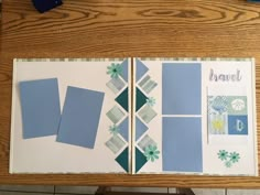 an open book with blue and green designs on the pages, sitting on a wooden table