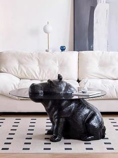 a living room with a couch, coffee table and animal figurines