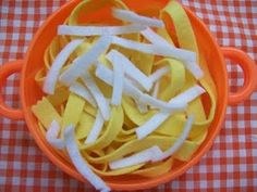 a bowl filled with pasta sitting on top of a checkered table cloth