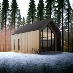 a small house in the middle of a snowy forest with a bicycle parked outside it