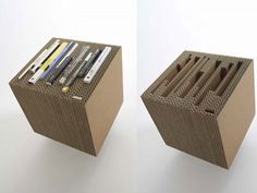 two cardboard boxes with pens, pencils and other items in them sitting side by side