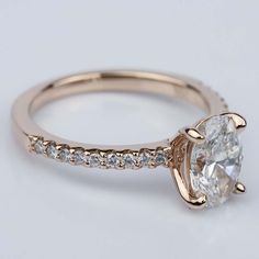 a close up view of a diamond engagement ring on a white background with gold accents