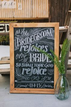 a chalkboard sign with the words as the bride and groom on it next to a plant