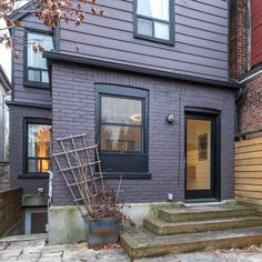 a purple house with steps leading up to the front door