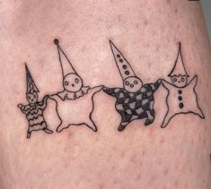 three small tattoos on the legs of people with clowns and cats in them,