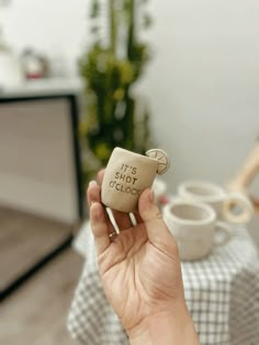 a person holding up a piece of wood that says it's hot in the oven