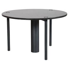 a round table with black metal legs