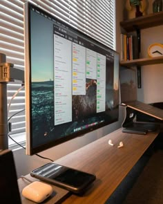 a computer monitor sitting on top of a wooden desk