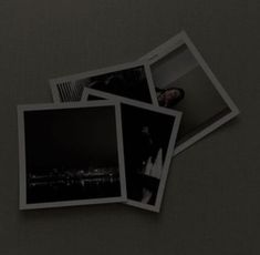 three polaroid photos sitting on top of a table