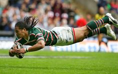 a rugby player dives for the ball during a game