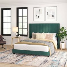 a bedroom with a green headboard and white bed in the center, two chairs on either side