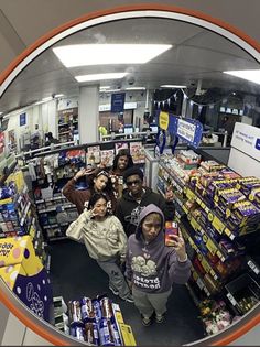 a group of people taking a selfie in a store's fish eye lens