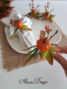 a person is holding some flowers on a plate