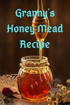 a glass jar filled with honey sitting on top of a table