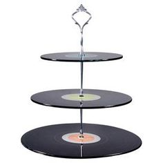 three tiered cake stand with vinyl records on each shelf and an acrylic stick sticking out of the top