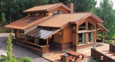 a wooden house in the woods with a picnic table