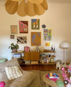 a living room filled with furniture and pictures on the wall