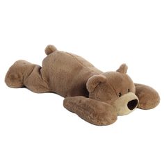 a brown teddy bear laying on its side