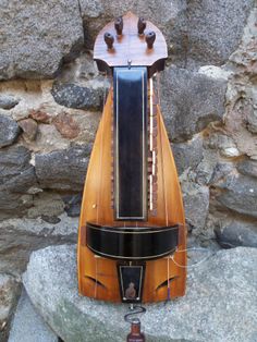 a musical instrument sitting on top of a rock