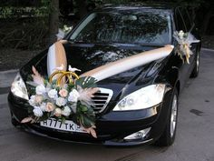 a wedding car decorated with flowers and a surfboard