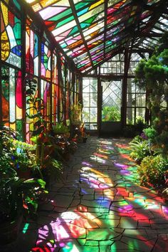 the sun shines through stained glass windows in a greenhouse