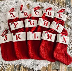 red and white christmas stockings with letters on them