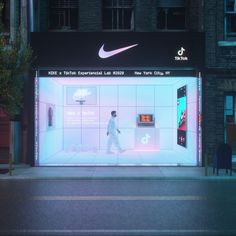 a man walking past a display window at night