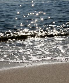 the sun shines on the water at the beach