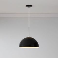 a black pendant light hanging from the ceiling